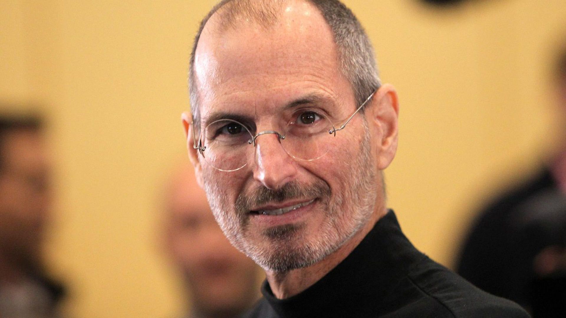 A smiling thin elderly man in glasses close-up
